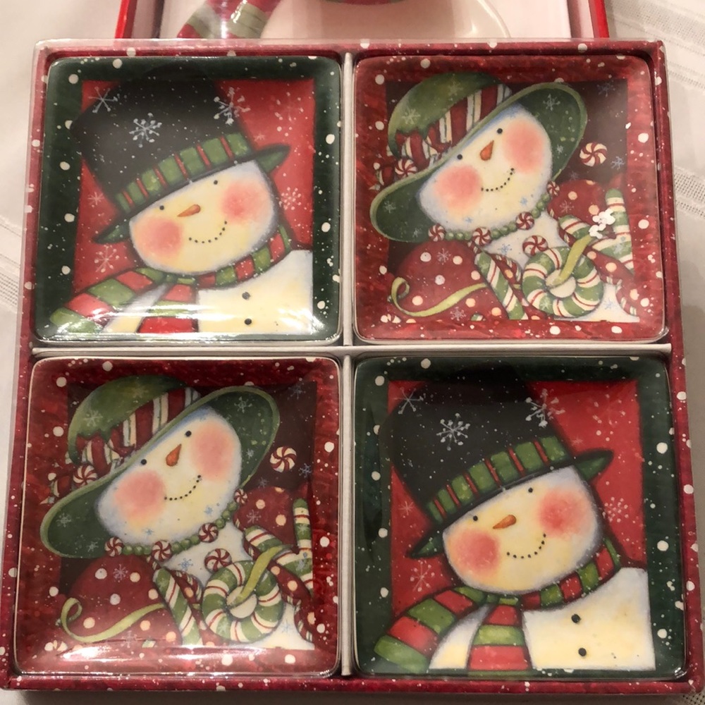 Set of 4 Lang Holiday Surprise Party Plates, featuring cute snowman designs.